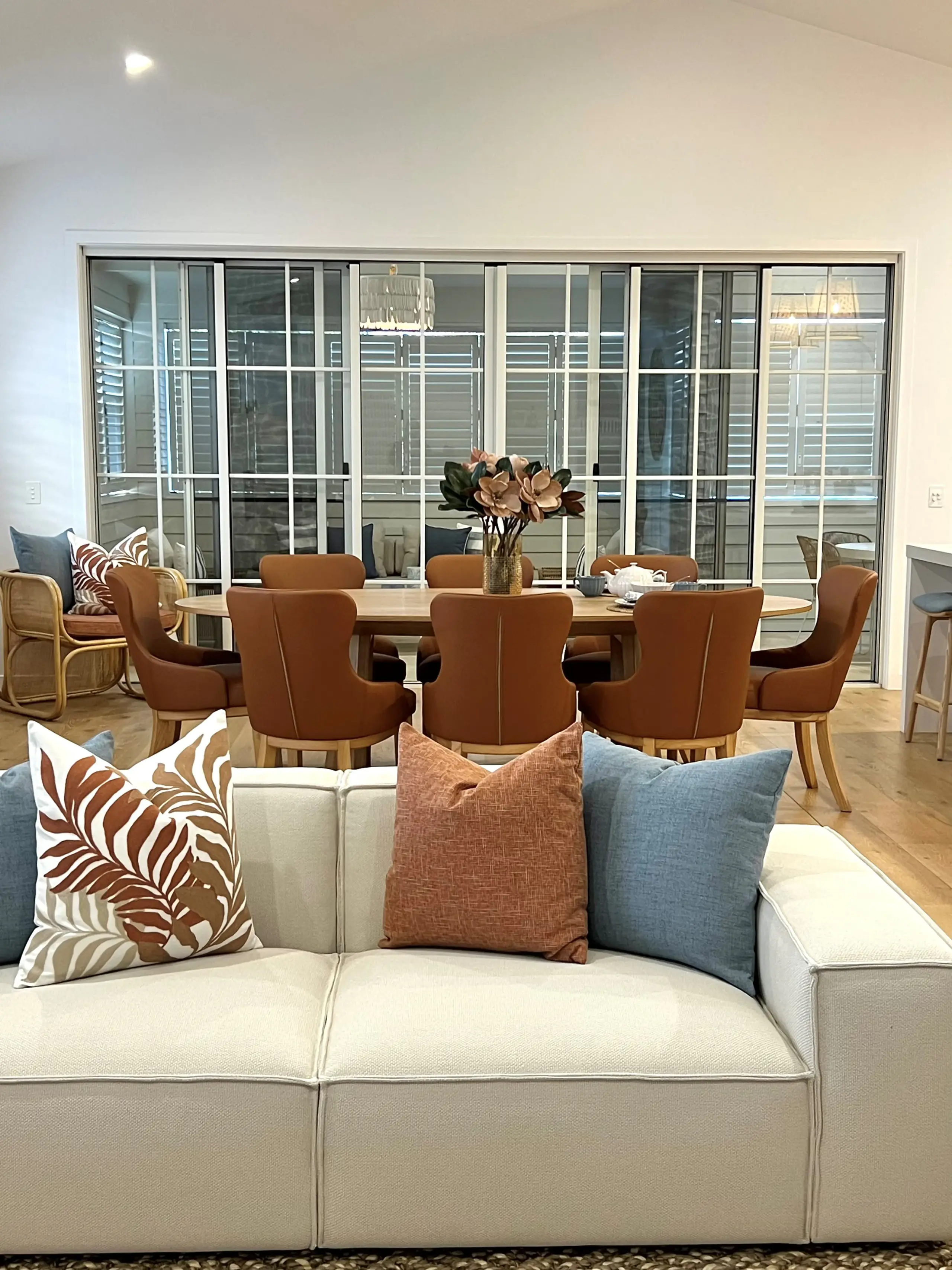 Golden Beach living and dining area with cream modular sofa, tan leather dining chairs and oak table